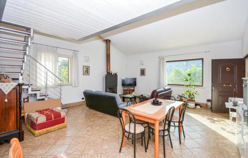 a living room with a table and chairs at 4 Bedroom Cozy Home In Ragusa in Ragusa