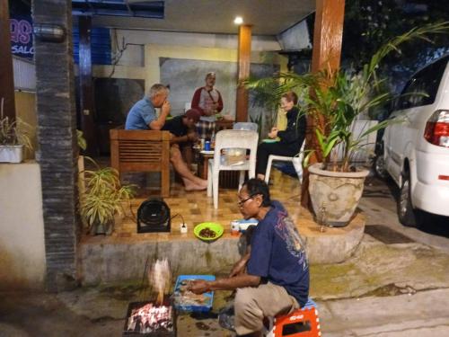 a group of people sitting at a table in a restaurant at Dannu's Homestay Ijen and Bromo Tour in Banyuwangi