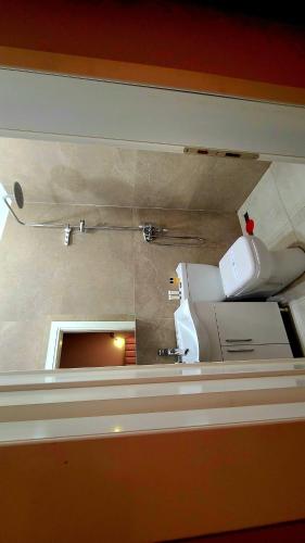 a bathroom with a toilet in a room at Hotel Alysa Korce in Korçë