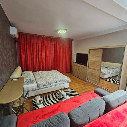 a living room with two beds and a couch at Apartment Savanovic in Banja Luka