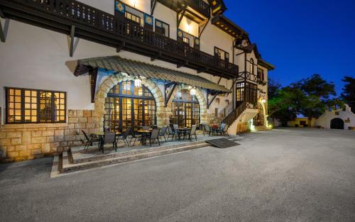 a building with a patio with tables and chairs at Elafos Hotel in Sálakos