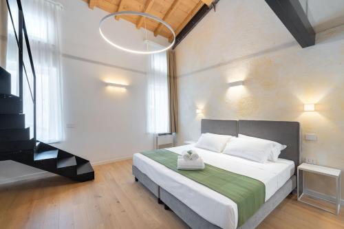 a bedroom with a bed and a television in it at Giulietta Luxury Suite in Verona