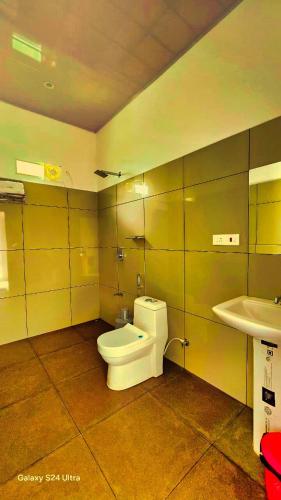 a bathroom with a toilet and a sink at Comfort Cove in Vythiri
