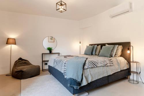 a bedroom with a bed and a mirror on the wall at Grapeful Stay - Canelli center - 8 pax - free park in Canelli