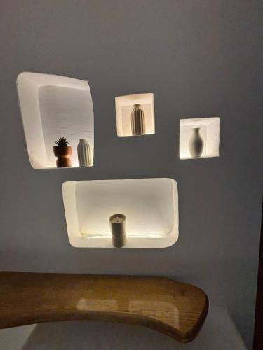 a bathroom with a sink and shelves on a wall at Houch Saramina in Midoun