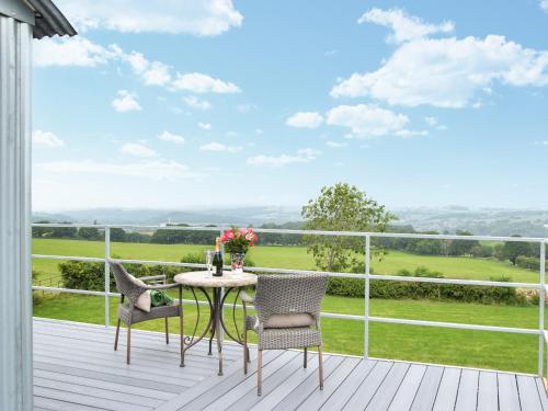 a patio with a table and chairs on a deck at Martha's Place in Bradley