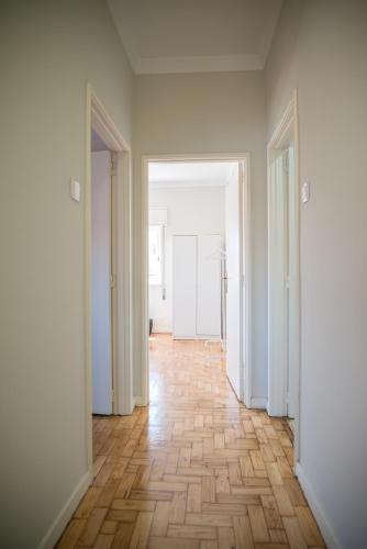 an empty room with white walls and a wooden floor at Alex Point - Guest House in Viana do Castelo
