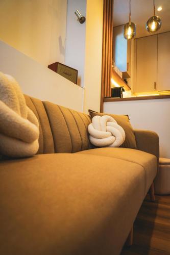 a brown couch with a white towel on it at Azur Pietra in Menton