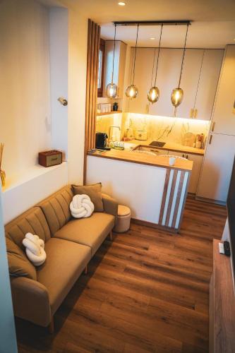 a living room with a couch and a kitchen at Azur Pietra in Menton