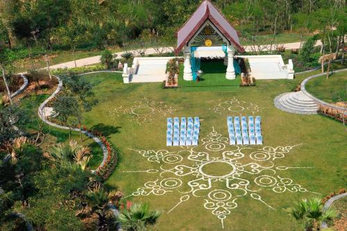 an aerial view of a garden with chairs and a house at Sheraton Grand Xishuangbanna Hotel in Jinghong