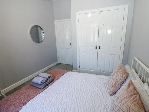 a bedroom with a bed with two towels on it at Lowther House in Whitehaven