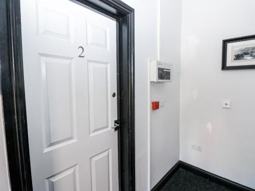 a white door with a black frame in a room at Lowther House in Whitehaven