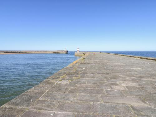 a long pier stretches out into the water at Lowther House in Whitehaven
