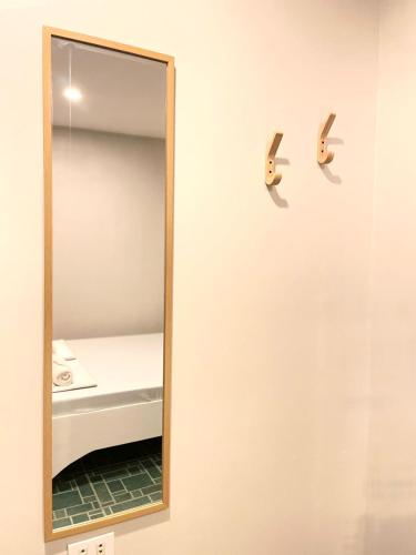 a mirror on a wall next to a bed at Chill Out Hostel in Boracay