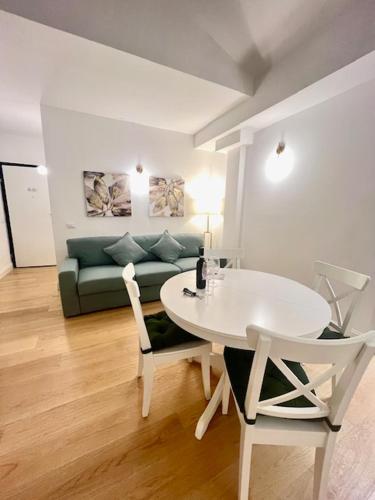 a living room with a table and a couch at Via Del Corso Home Roma in Rome