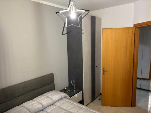 a bedroom with a bed and a star hanging from the ceiling at Silvana Home in Marina di Sorso
