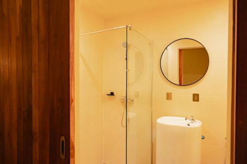 a bathroom with a shower and a sink and a mirror at Metro Pratunam Boutique Hotel in Pratunam