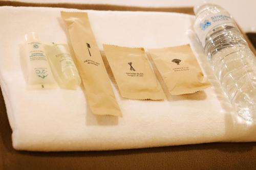 a white plate with a bottle of water and towels at Metro Pratunam Boutique Hotel in Pratunam