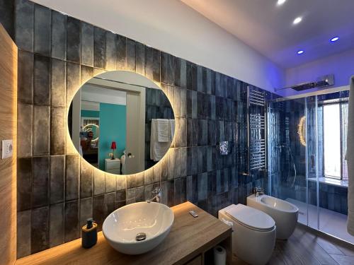 a bathroom with two sinks and a mirror at Isoco House in Taormina