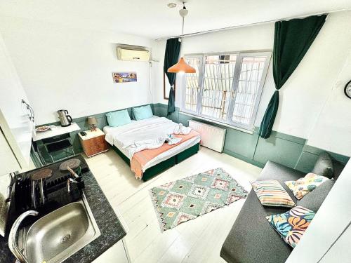 a small room with a bed and a sink at Taksim Amur Mansion Hotel in Istanbul