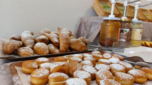 a bunch of donuts and other pastries on a table at Hotel Condor in Milano Marittima