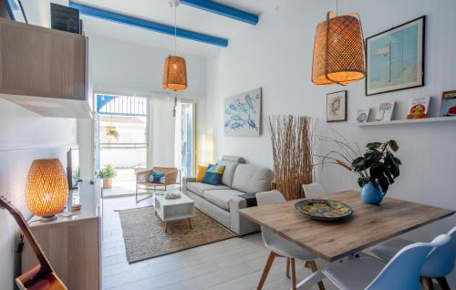 a living room with a table and a couch at Lovely Home In Punta Braccetto in Punta Braccetto