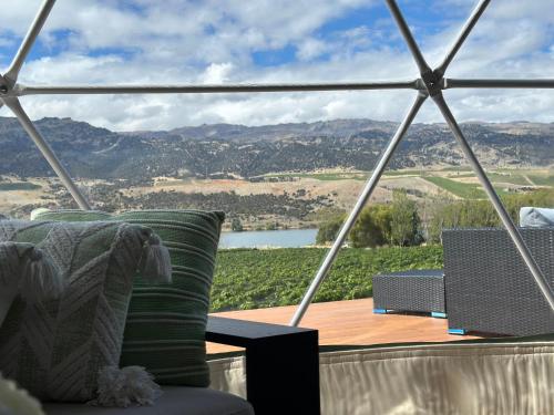 a room with a table and a view of the mountains at Glamping Dome - Pinot in Cromwell
