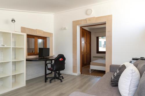a living room with a desk and a bedroom at Townhouse Ses Passadores in Porreres