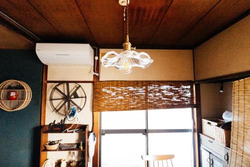 a chandelier hanging from a ceiling in a room at guesthouse TANDEM in Matsumoto