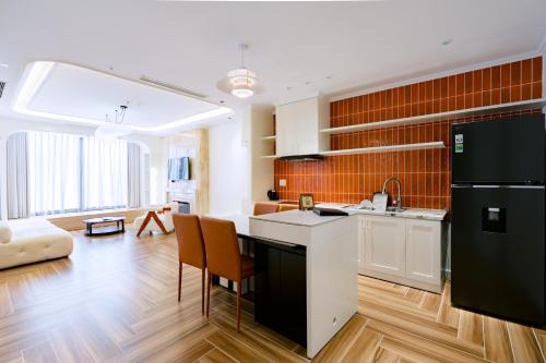 a kitchen with a black and white refrigerator at HN Apartment and Hotel in Tài Xá