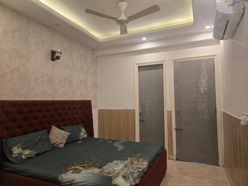a bedroom with a bed and a ceiling fan at The Green Door Tricity in Zirakpur
