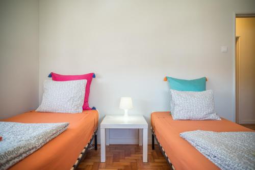 two twin beds sitting next to each other in a room at Alex Point - Guest House in Viana do Castelo