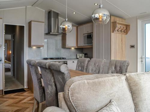 a kitchen and dining room with a table and chairs at Gill Bay - Uk45513 in Mainsriddle