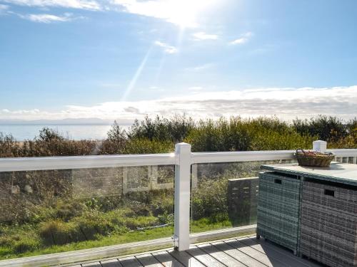 a balcony with a view of the ocean at Gill Bay - Uk45513 in Mainsriddle