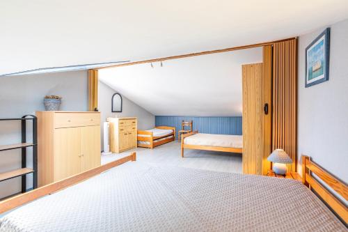 a bedroom with a large sliding glass door to a bedroom at Maison avec Jardin proche Océan in Saint-Denis-dʼOléron
