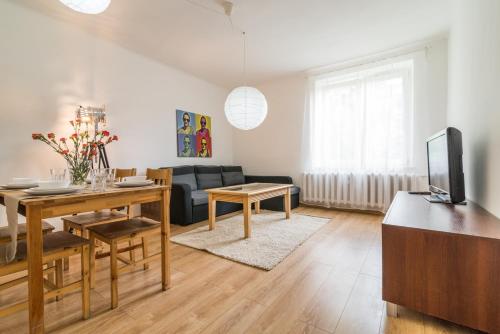 a living room with a couch and a table at Apartament Ku Słońcu - Hel in Hel