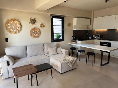 a living room with a couch and a table at Villa El Mar in Gerakini