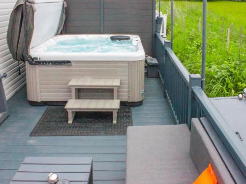 a hot tub and a bench on a deck at Long View Lodge in Felton