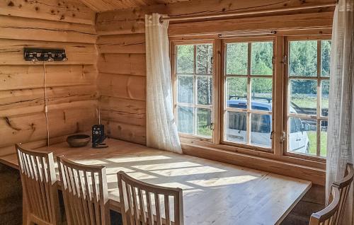 a dining room with a wooden table and a window at 4 Bedroom Stunning Home In Tynset in Tynset