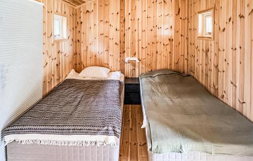 a bedroom with two beds in a wooden cabin at 4 Bedroom Stunning Home In Tynset in Tynset