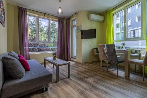 a living room with a couch and a table at My Space Deluxe One Bedroom Apartment in Sofia