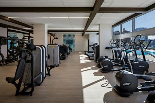 a gym with a row of treadmills and machines at Omaha Marriott Downtown at the Capitol District in Omaha