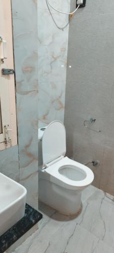 a bathroom with a white toilet and a sink at Hotel AL Taj , Agra in Agra