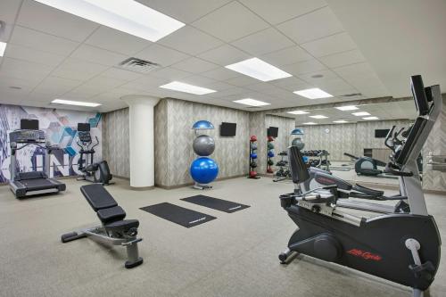 a gym with treadmills and machines in a room at SpringHill Suites by Marriott Milwaukee Downtown in Milwaukee