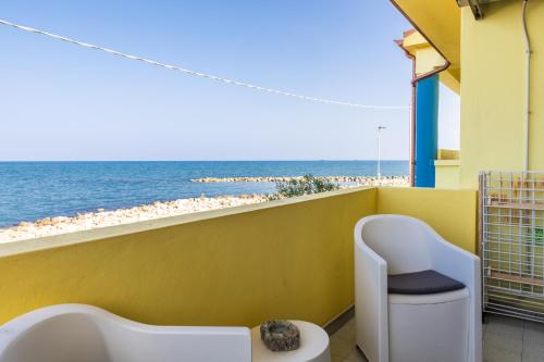 a balcony with a toilet and a view of the beach at Villa Fausta in La Maddalena