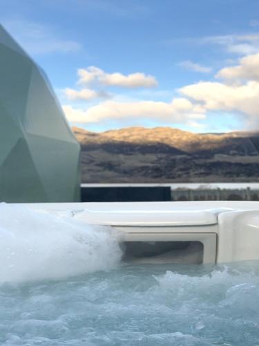 a bed on top of a body of water at Glamping Dome - Rosé in Cromwell
