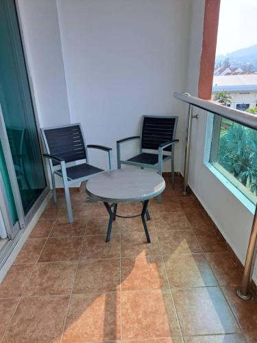 two chairs and a table on a balcony at Marina Island Ocean Theme @ Lumut Sitiawan in Lumut