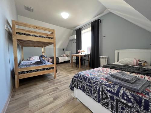 a bedroom with two bunk beds and a desk at Гостевой Отель-125 in Aktau