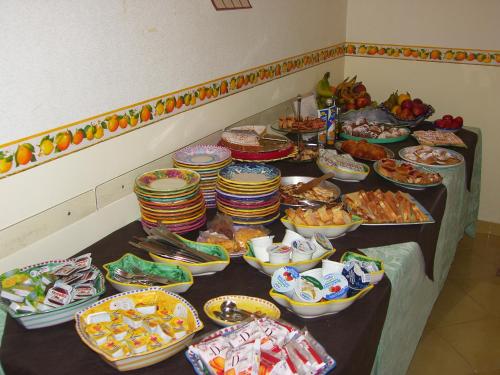 a buffet with plates and bowls of food on a table at Locanda Degli Agrumi in Conca dei Marini