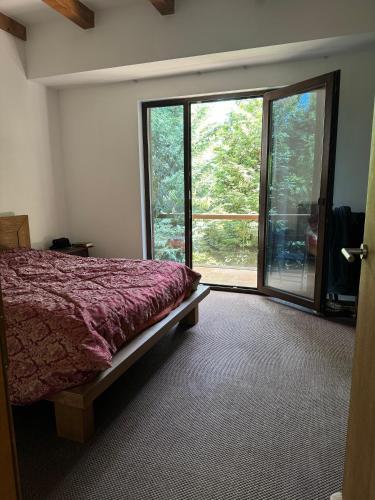 a bedroom with a bed and a large window at Luxury Villa in Cluj-Napoca